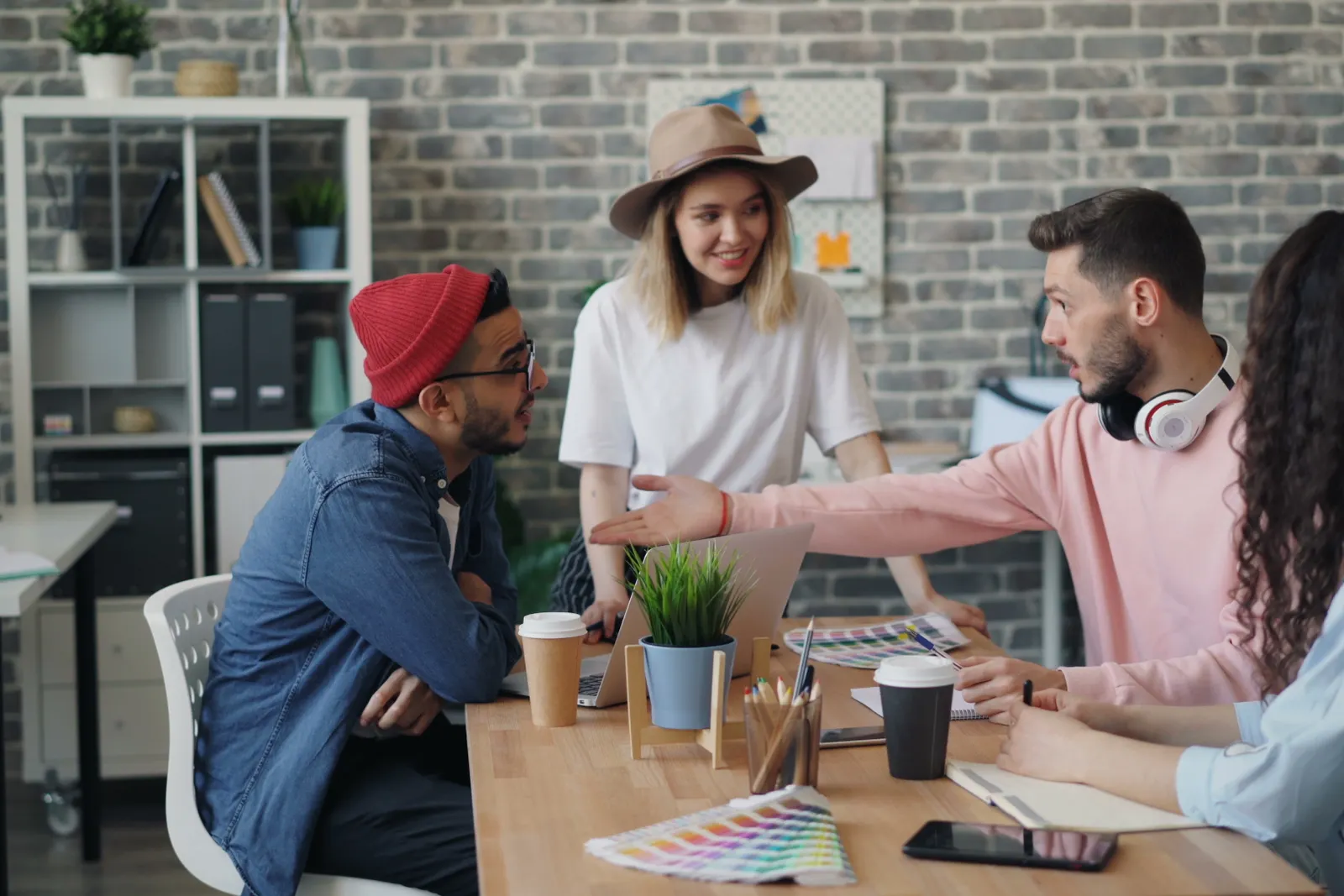 Group of young professionals brainstorming ideas in a modern office environment.