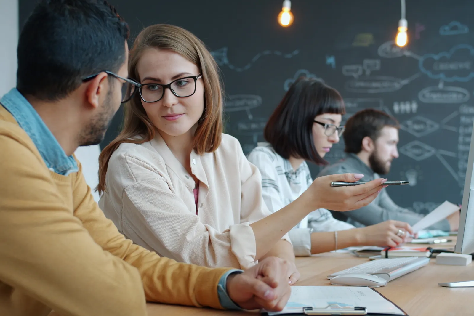Group of young professionals collaborating in a creative modern workspace.