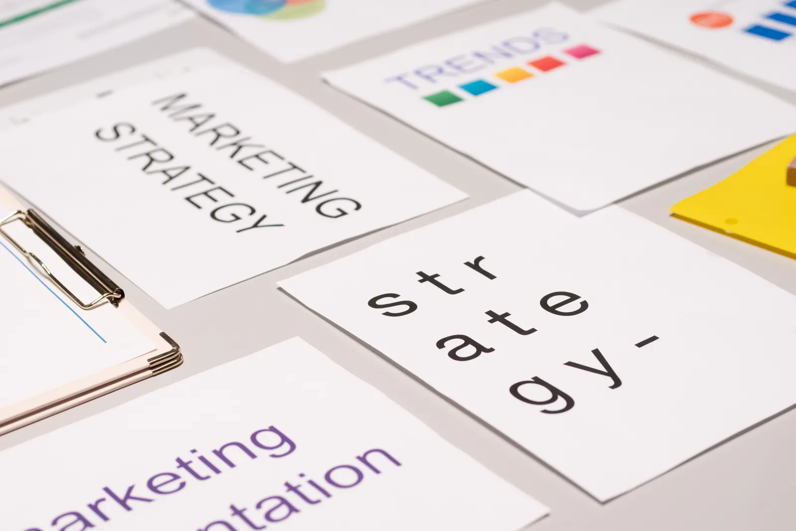 A top view of marketing strategy documents and graphs arranged on a desk, showcasing business planning.