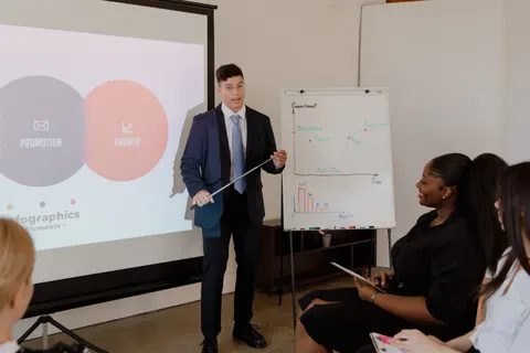 Junge Fachkraft pr&auml;sentiert in einem Meeting eine Wachstumsstrategie anhand von Diagrammen und Grafiken.