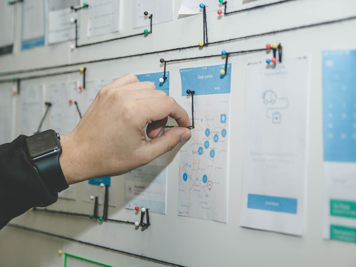 Planning a website structure on a wall of wireframes